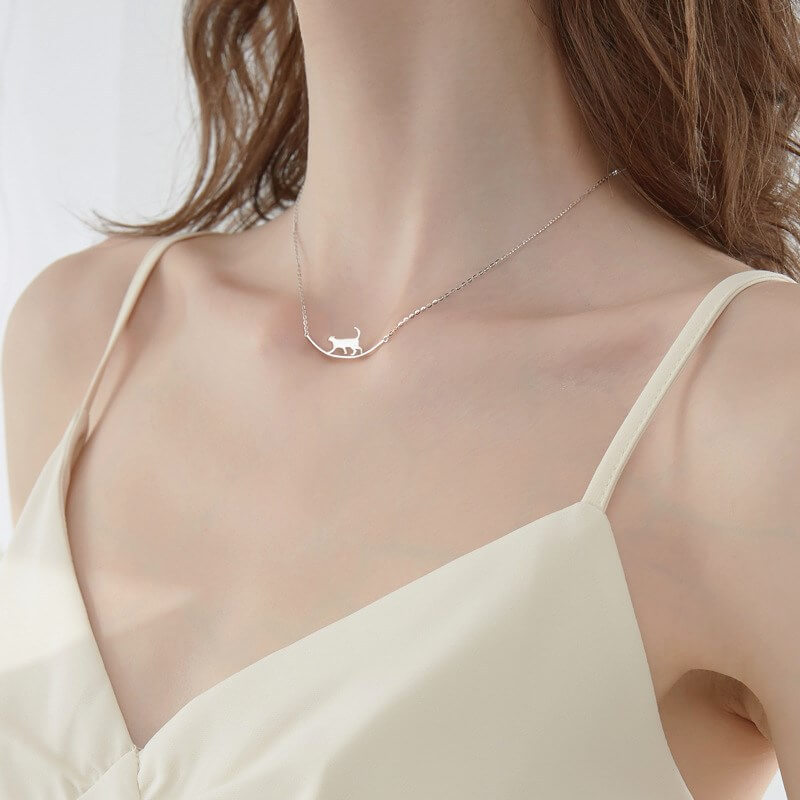 Sterling silver cat walking on bar necklace (worn by model).