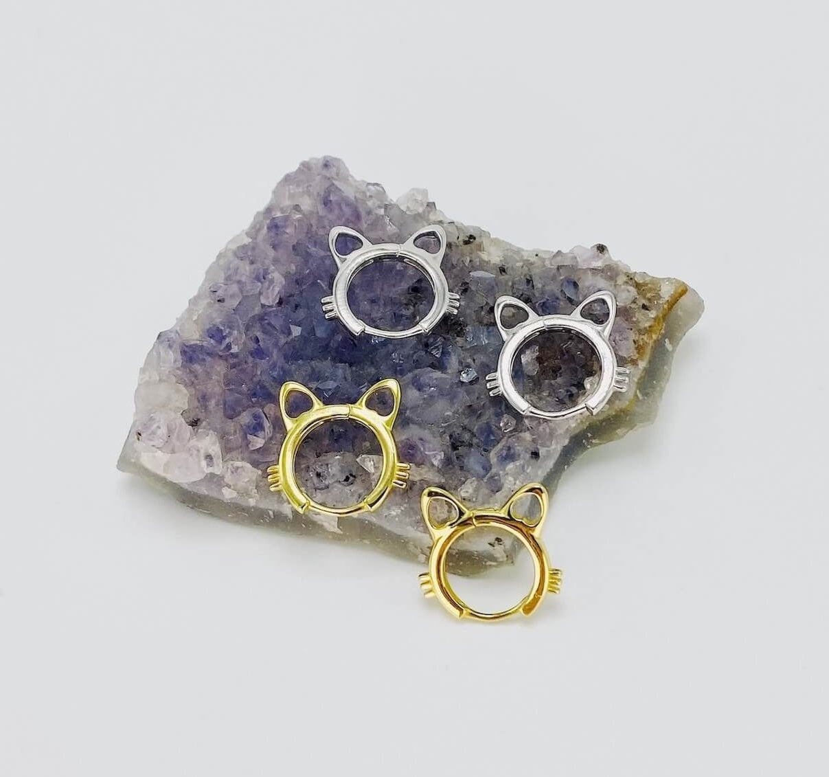 Sterling silver cat head hoop earrings in gold and silver.