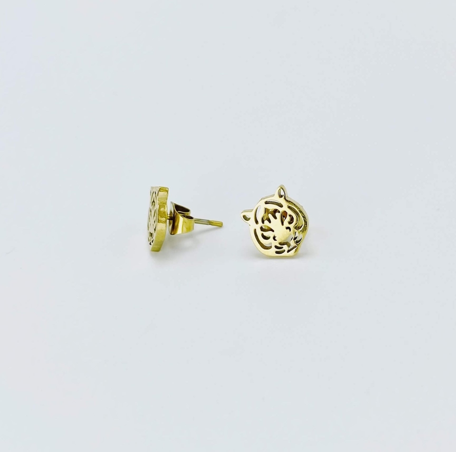 Metallic tiger stud earrings in a yellow gold hue made from stainless steel.