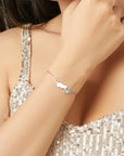 Sterling silver bracelet with cat and opal charm (worn by model).