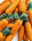 Grouping of orange carrot felted wool cat toys.