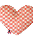 Heart shaped squeaker dog toy in an orange and white gingham print. Made in USA label on bottom trim.