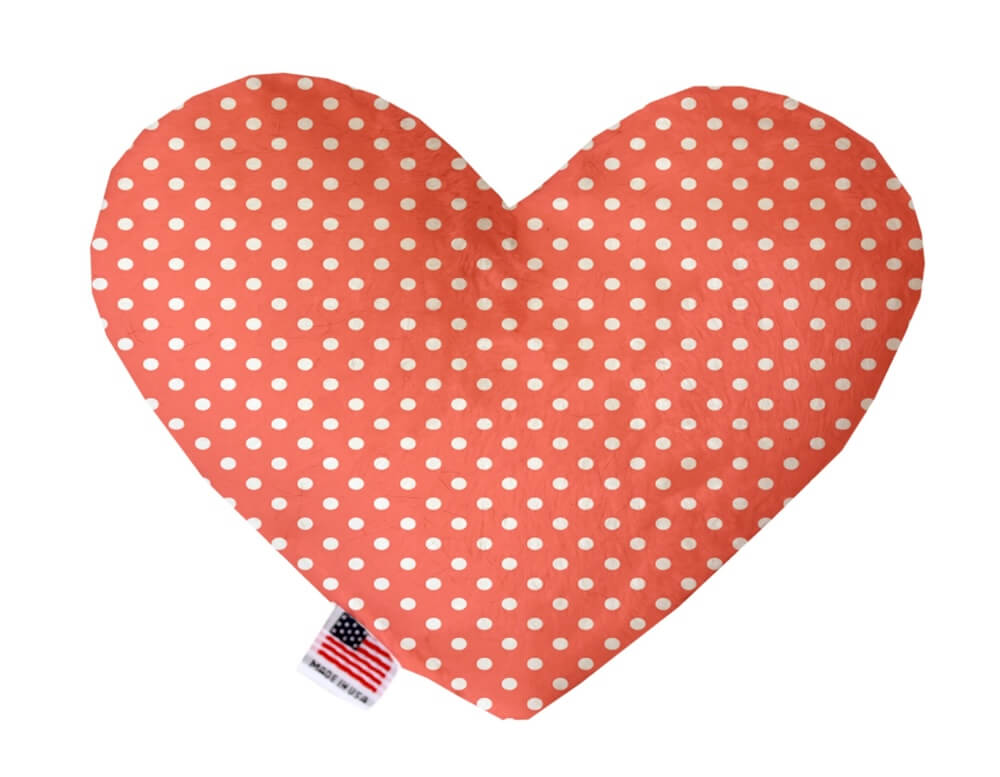 Heart shaped squeaker dog toy. Orange background with white polka dots. Made in USA label on bottom trim.