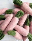 Grouping of pink carrot felted wool cat toys.