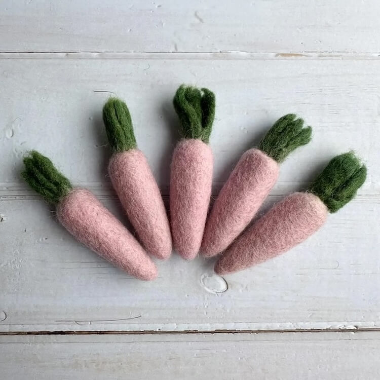 Grouping of pink carrot felted wool cat toys.