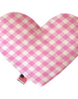 Heart shaped squeaker dog toy in a pink and white gingham print. Made in USA label on bottom trim.