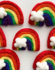 Rainbow wool cat toys with white cloud accents.