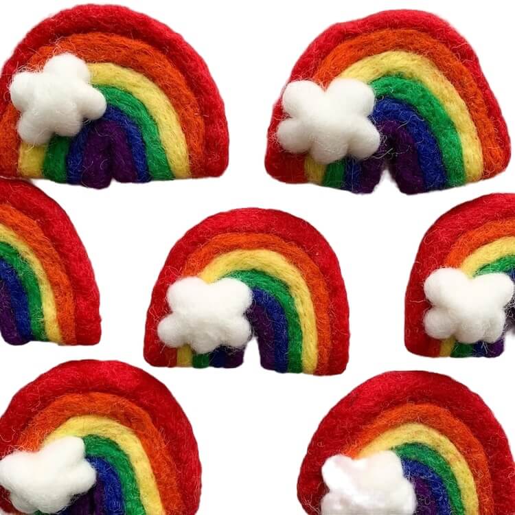 Rainbow wool cat toys with white cloud accents.