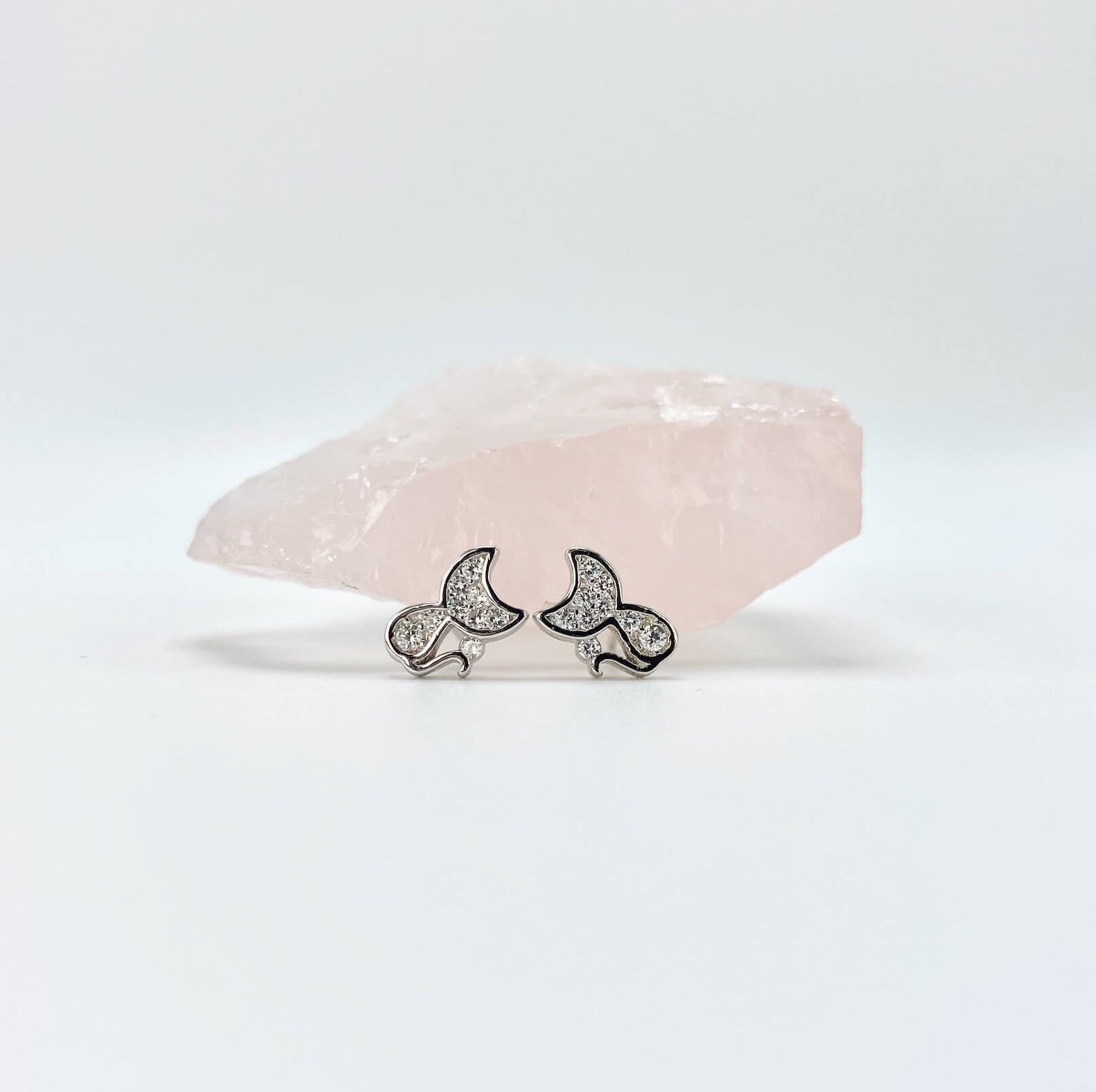 Sterling silver cat earring studs with moon shaped heads and cubic zirconia gemstones. Very small.