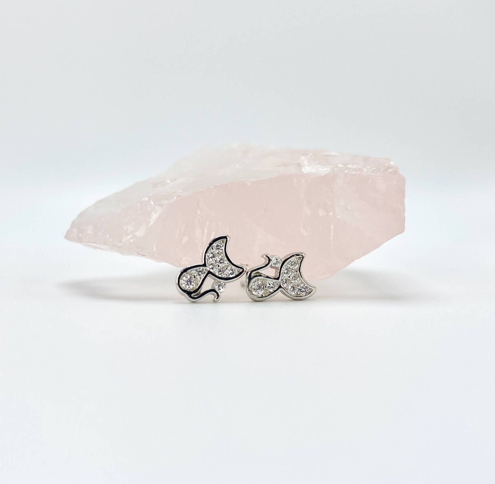 Sterling silver cat earring studs with moon shaped heads and cubic zirconia gemstones. Very small.
