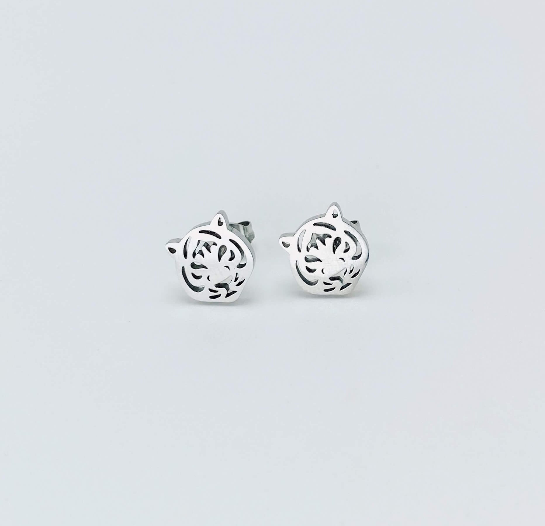 Metallic tiger stud earrings in a silver hue made from stainless steel.