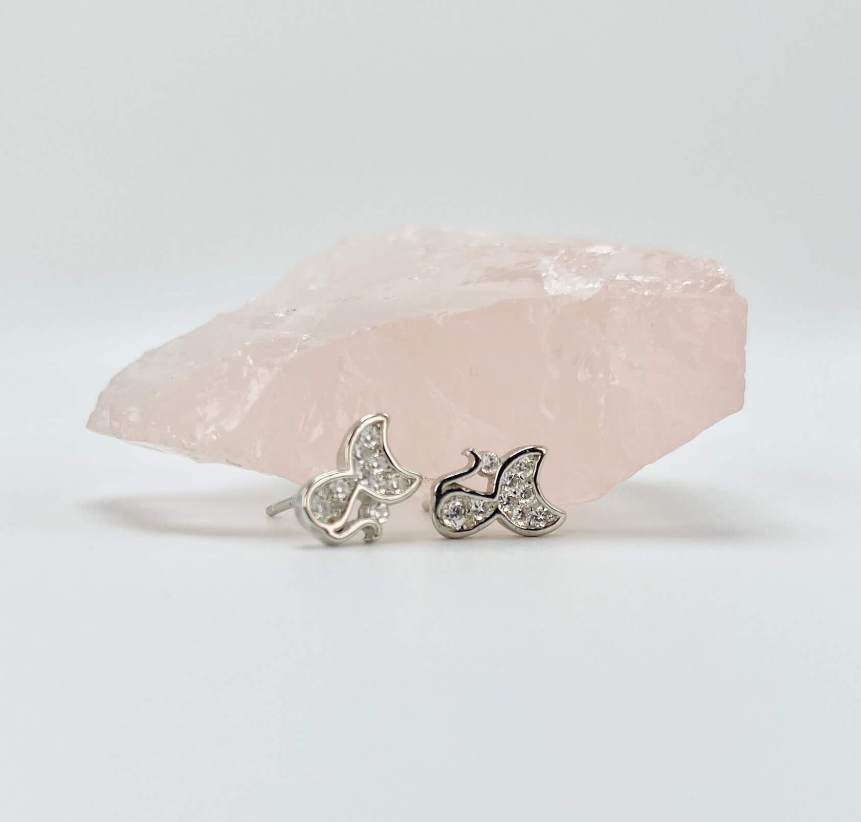 Sterling silver cat earring studs with moon shaped heads and cubic zirconia gemstones. Very small.