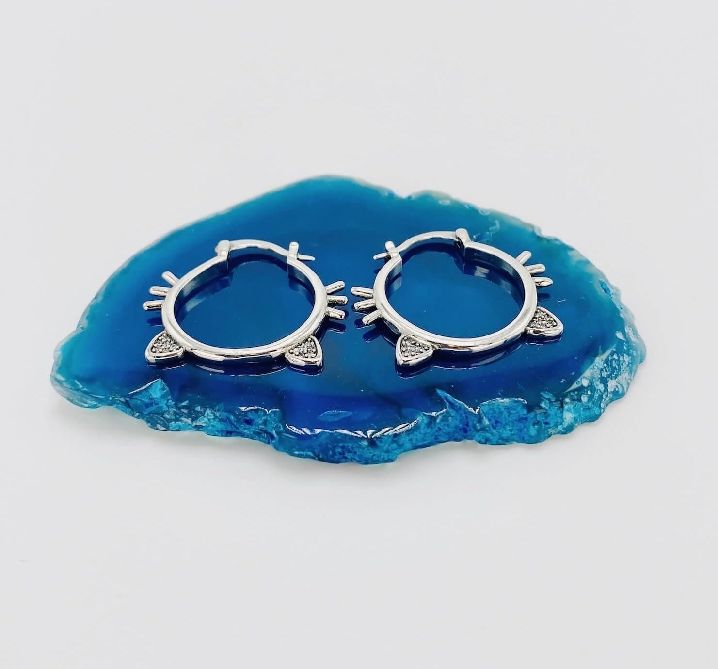 Sterling silver hoop earrings with cat ears and whiskers.