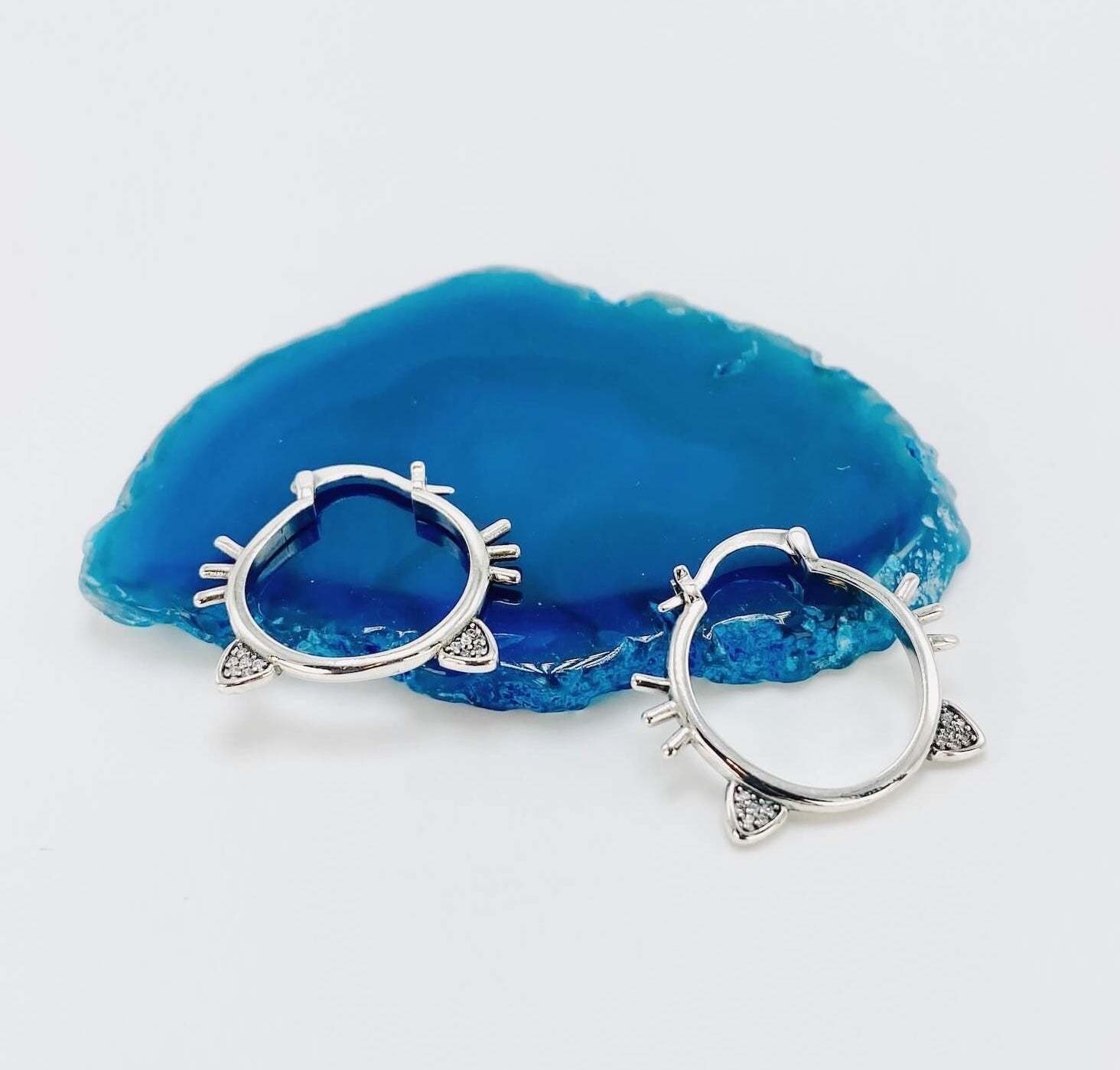 Sterling silver hoop earrings with cat ears and whiskers.