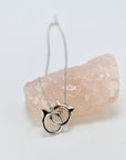 Sterling silver cat infinity necklace. Features two cat head charms that are linked.
