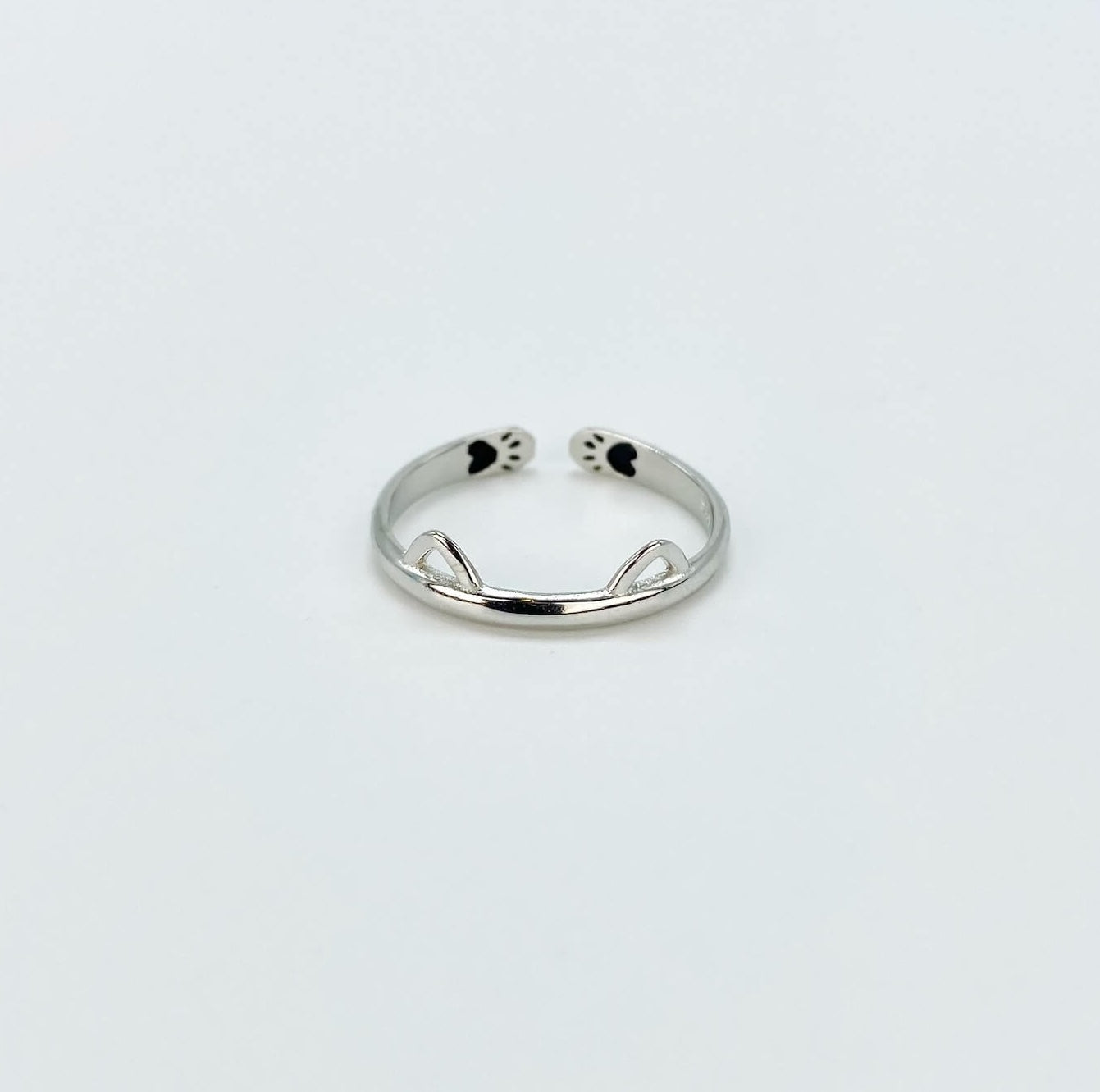 Sterling silver band ring with cat ears and hidden paw prints.