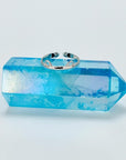 Sterling silver band ring with cat ears sitting on blue crystal stand.