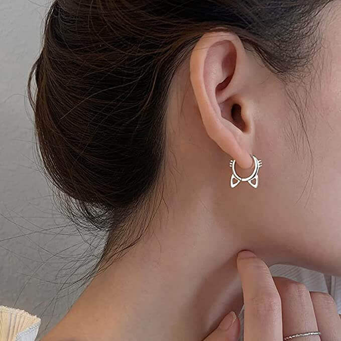 Sterling silver cat head hoop earrings (worn by model).
