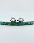 Sterling silver cubic zirconia cat huggie earrings.