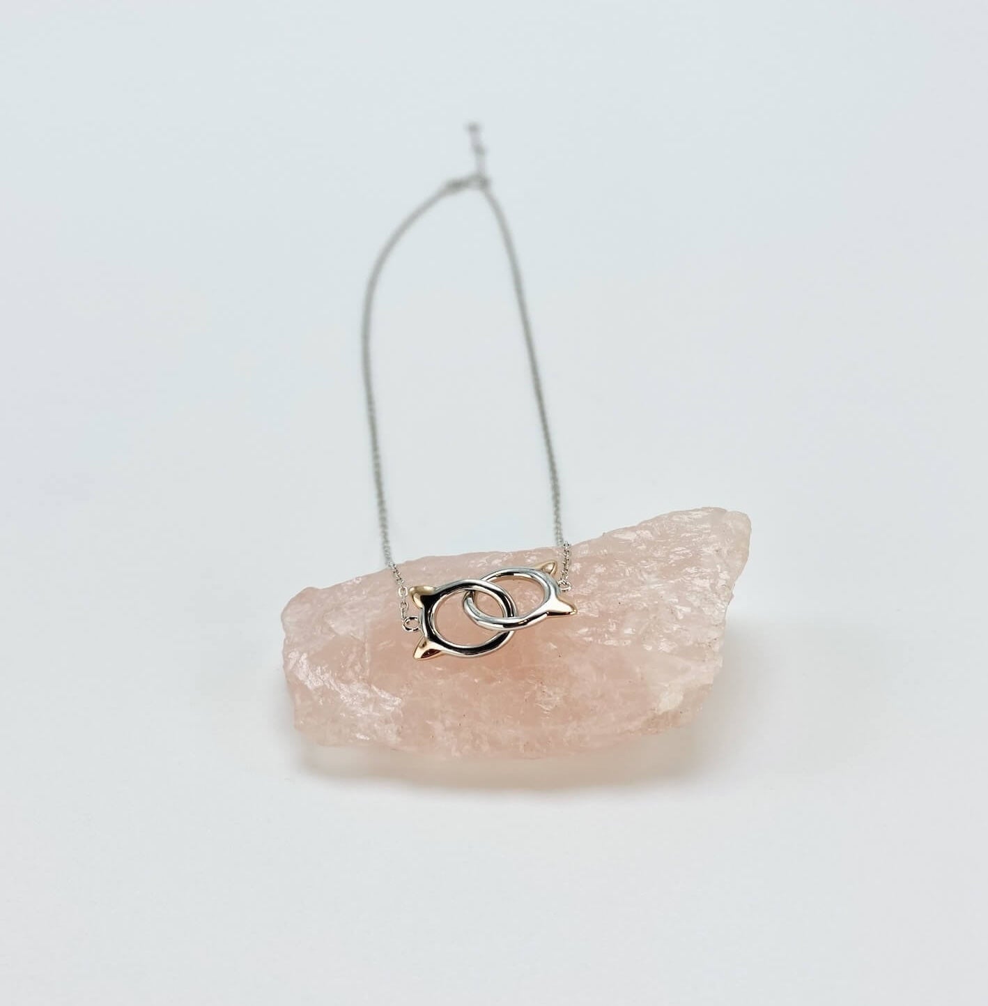 Sterling silver cat infinity necklace. Features two cat head charms that are linked.