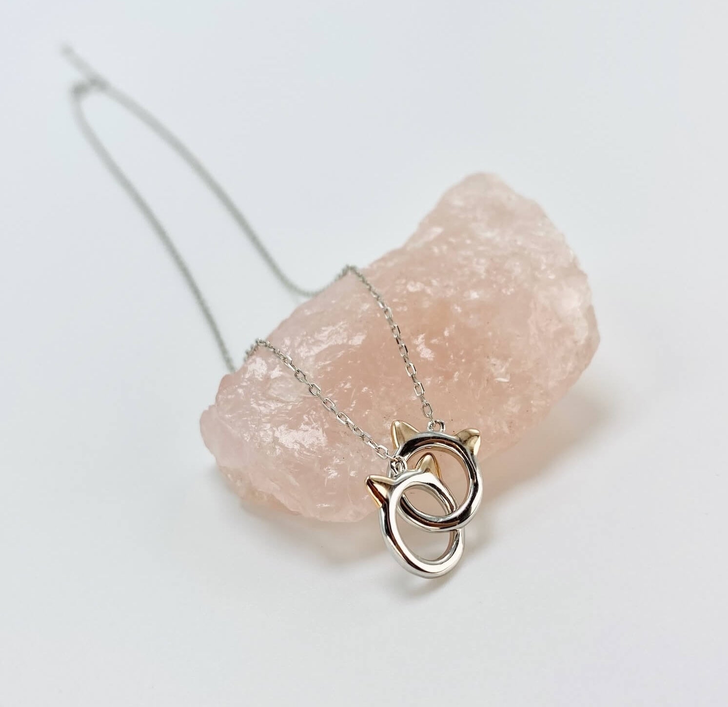Sterling silver cat infinity necklace. Features two cat head charms that are linked.