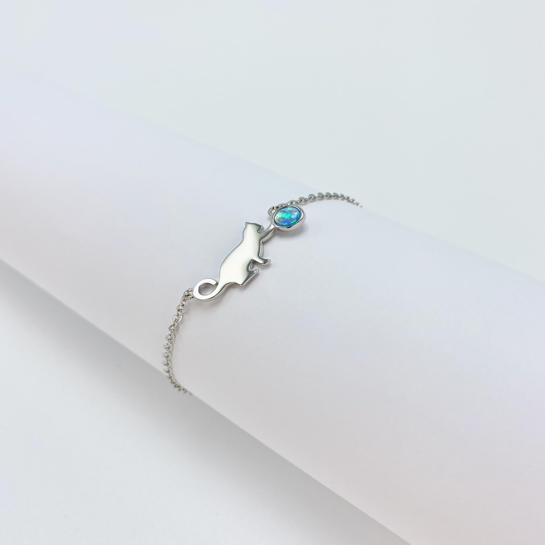 Sterling silver bracelet with cat and opal charm.