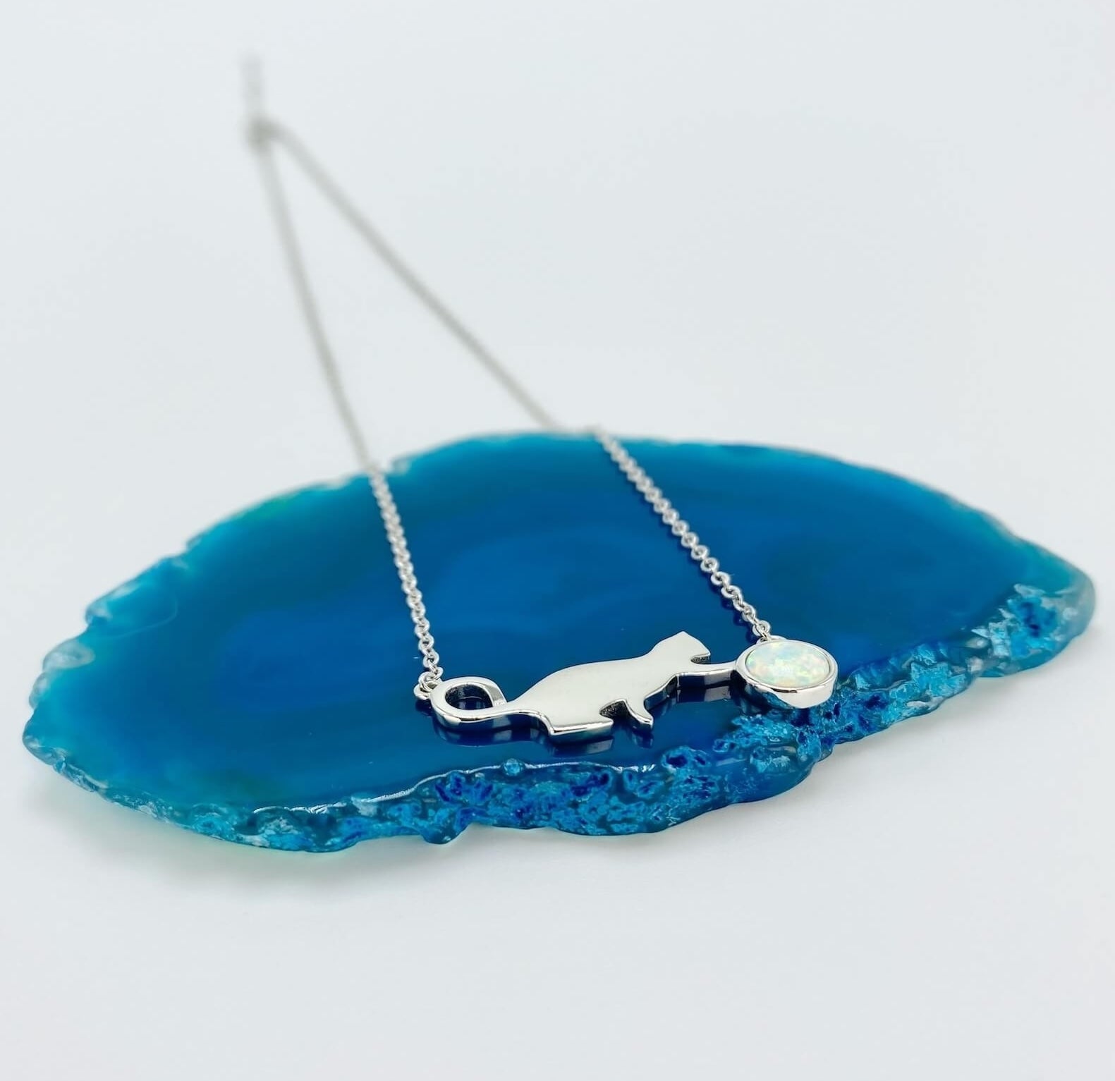 Sterling silver necklace with cat and opal charm.