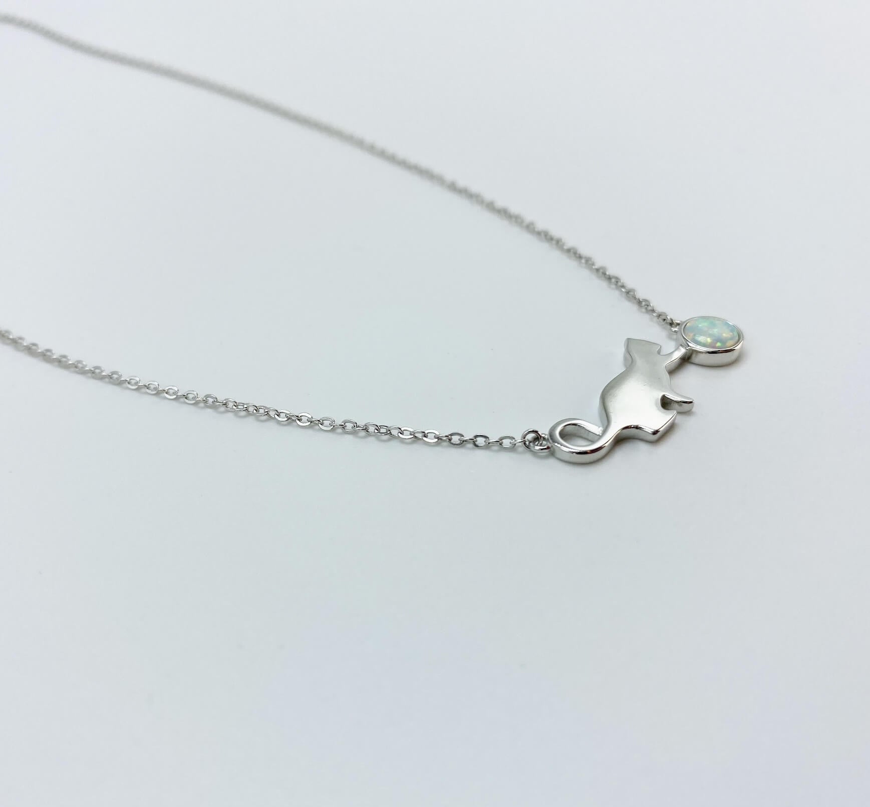 Sterling silver necklace with cat and opal charm.
