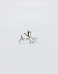 Sterling silver ring that features a cat chasing a butterfly.