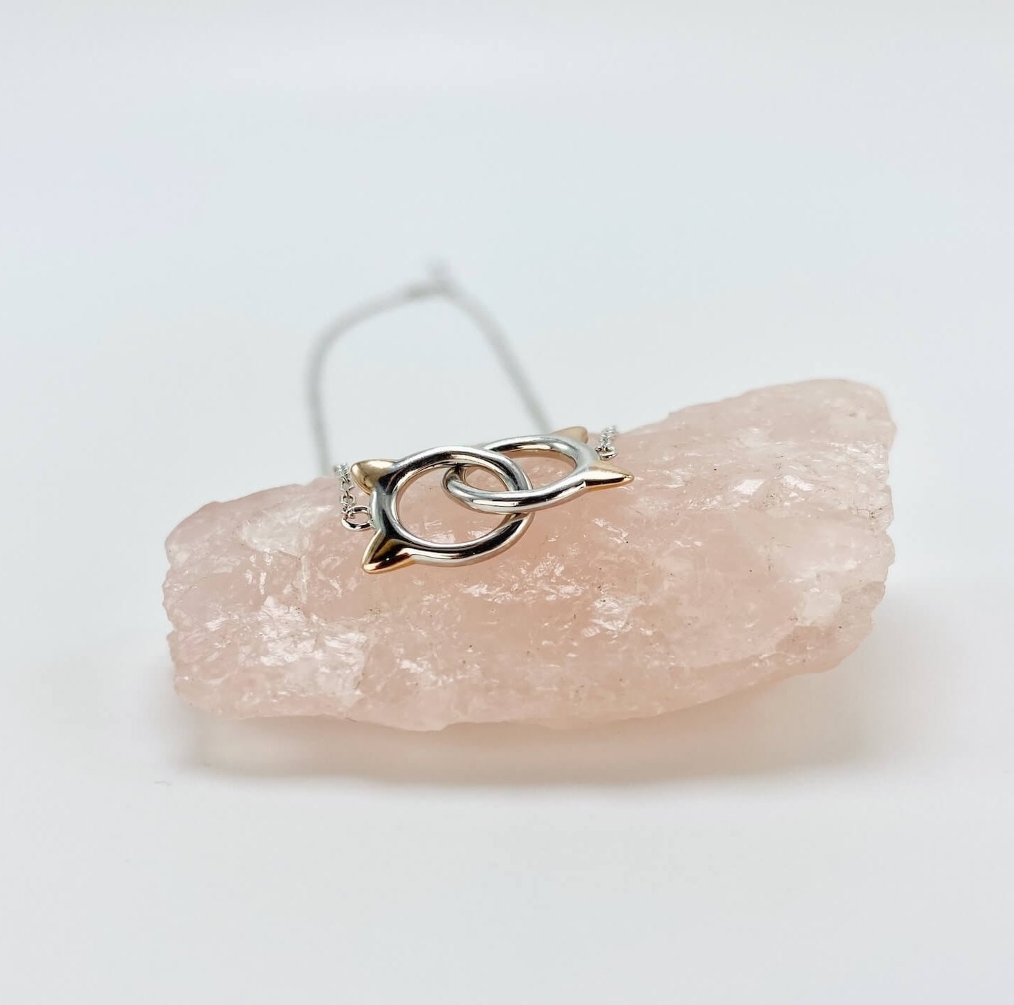 Sterling silver cat infinity necklace. Features two cat head charms that are linked.