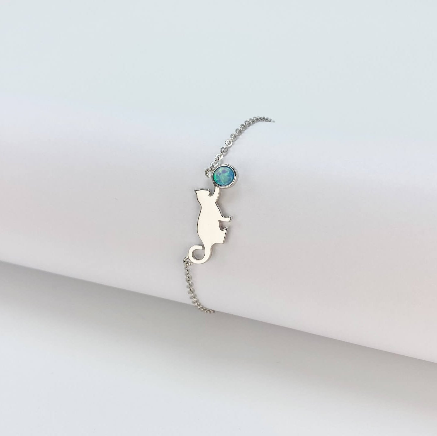Sterling silver bracelet with cat and opal charm.