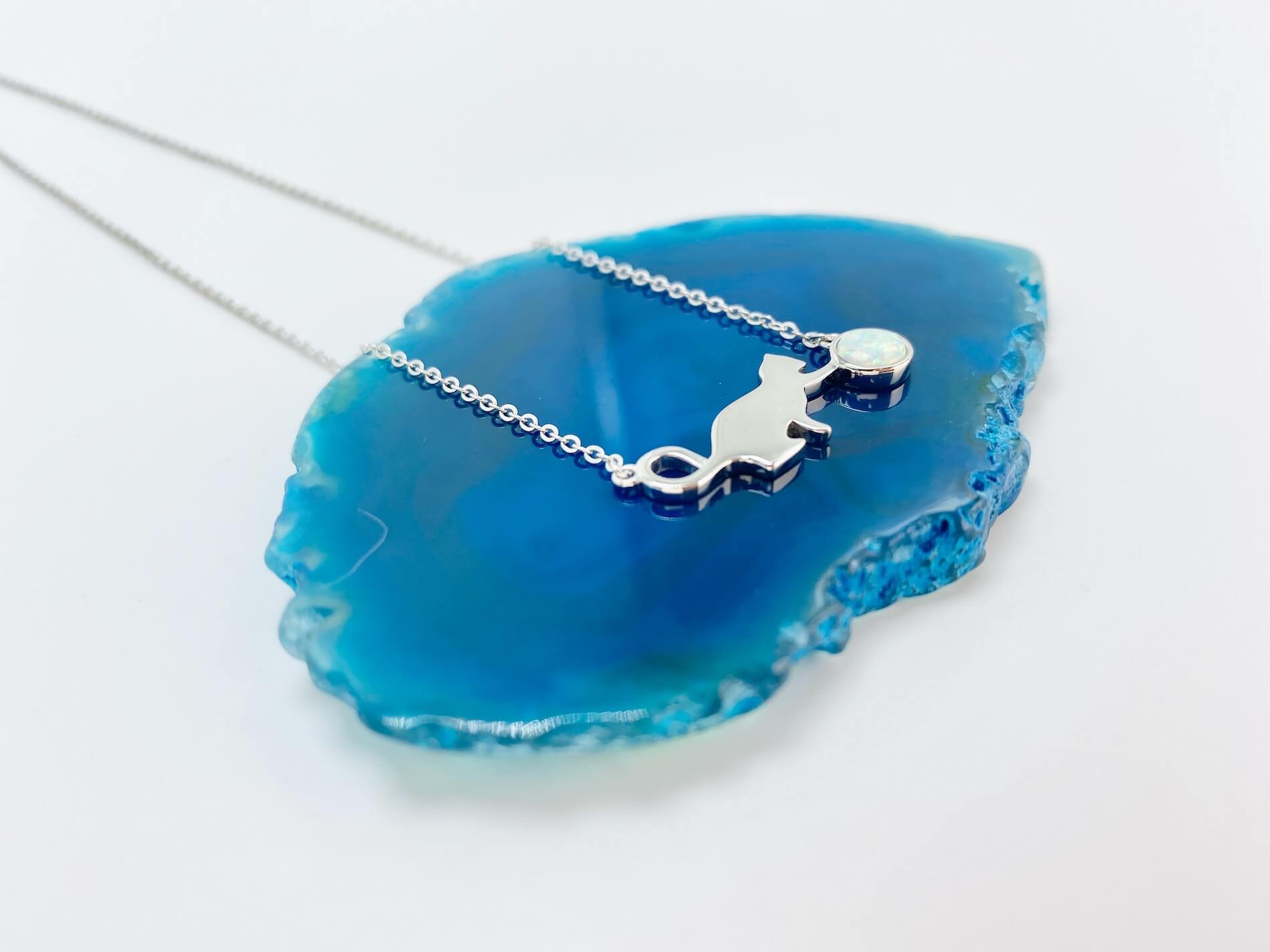 Sterling silver necklace with cat and opal charm.