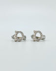 Sterling silver cubic zirconia cat huggie earrings.