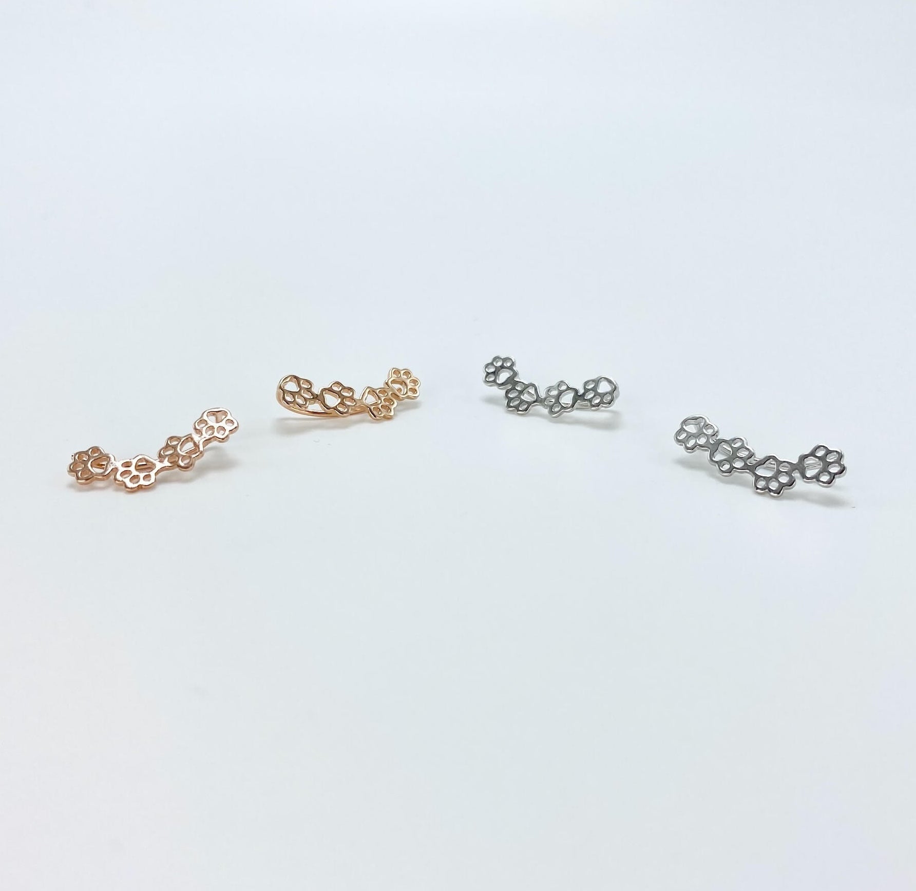 Sterling silver paw print climber earrings in rose gold and silver.