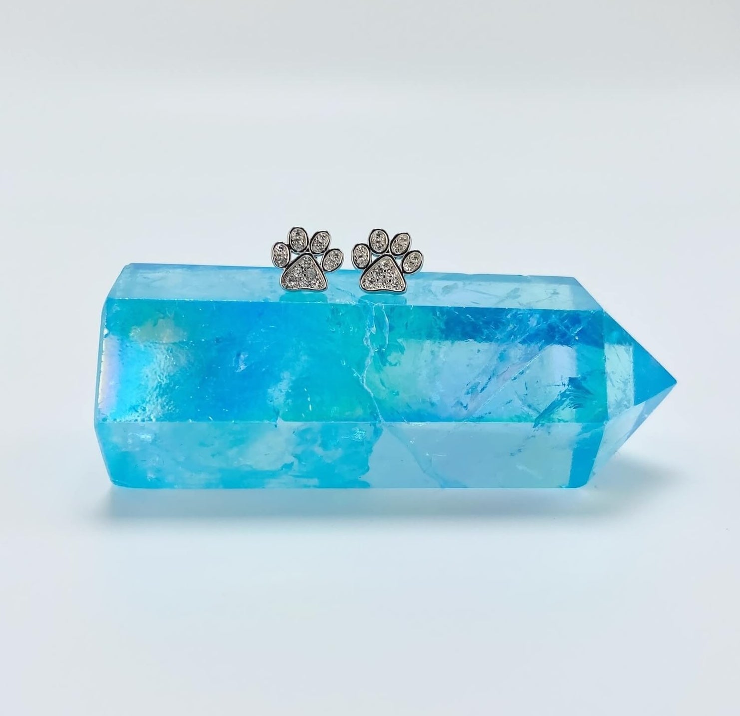 Sterling silver paw earring studs with cubic zirconia gemstones.