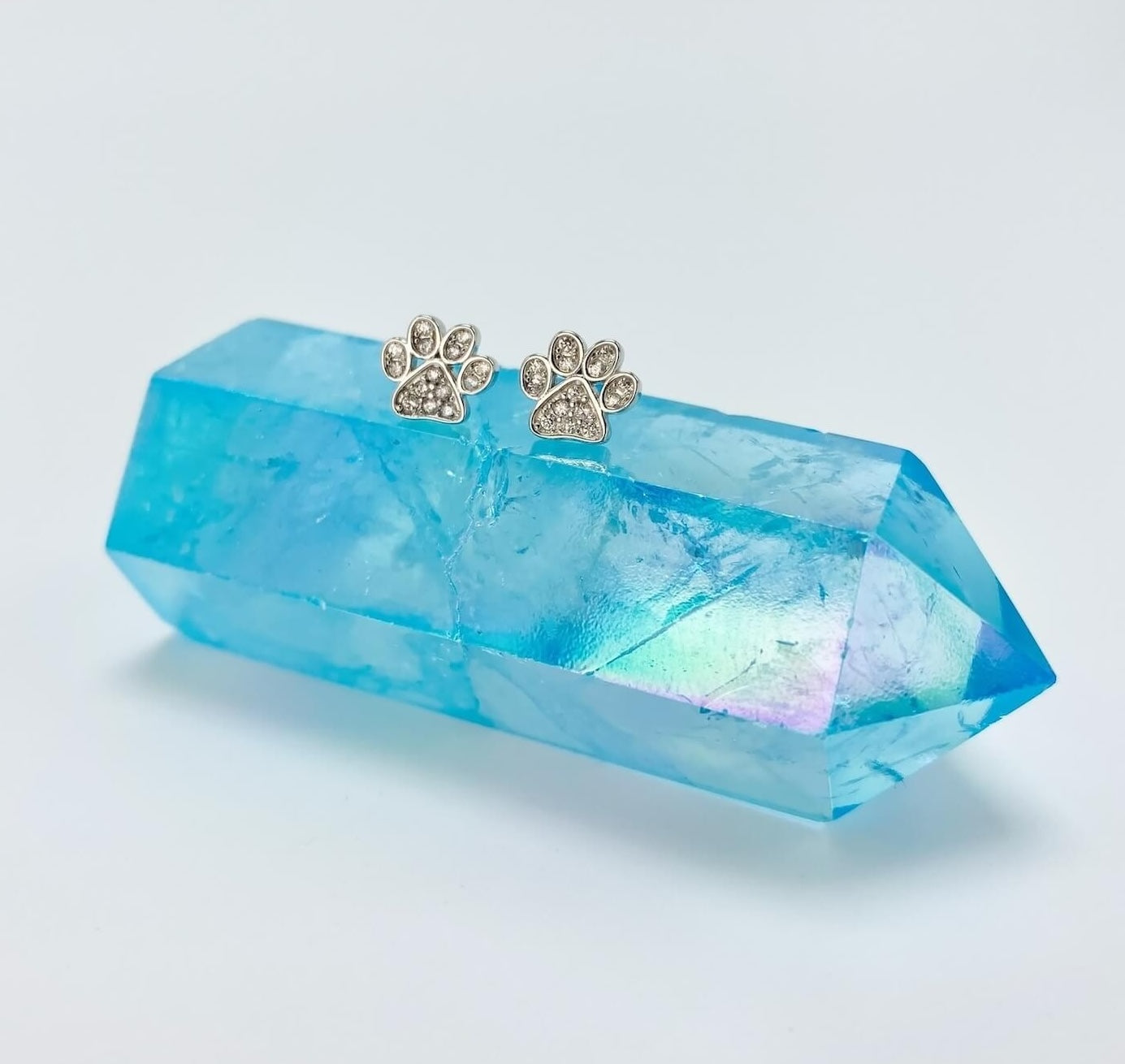 Sterling silver paw earring studs with cubic zirconia gemstones.