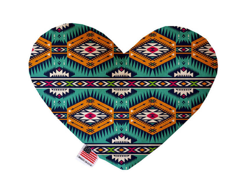 Heart shaped squeaker dog toy. Southwestern print. Main color is turquoise, with orange, pink, off-white and green accent colors. Made in USA label on bottom trim.