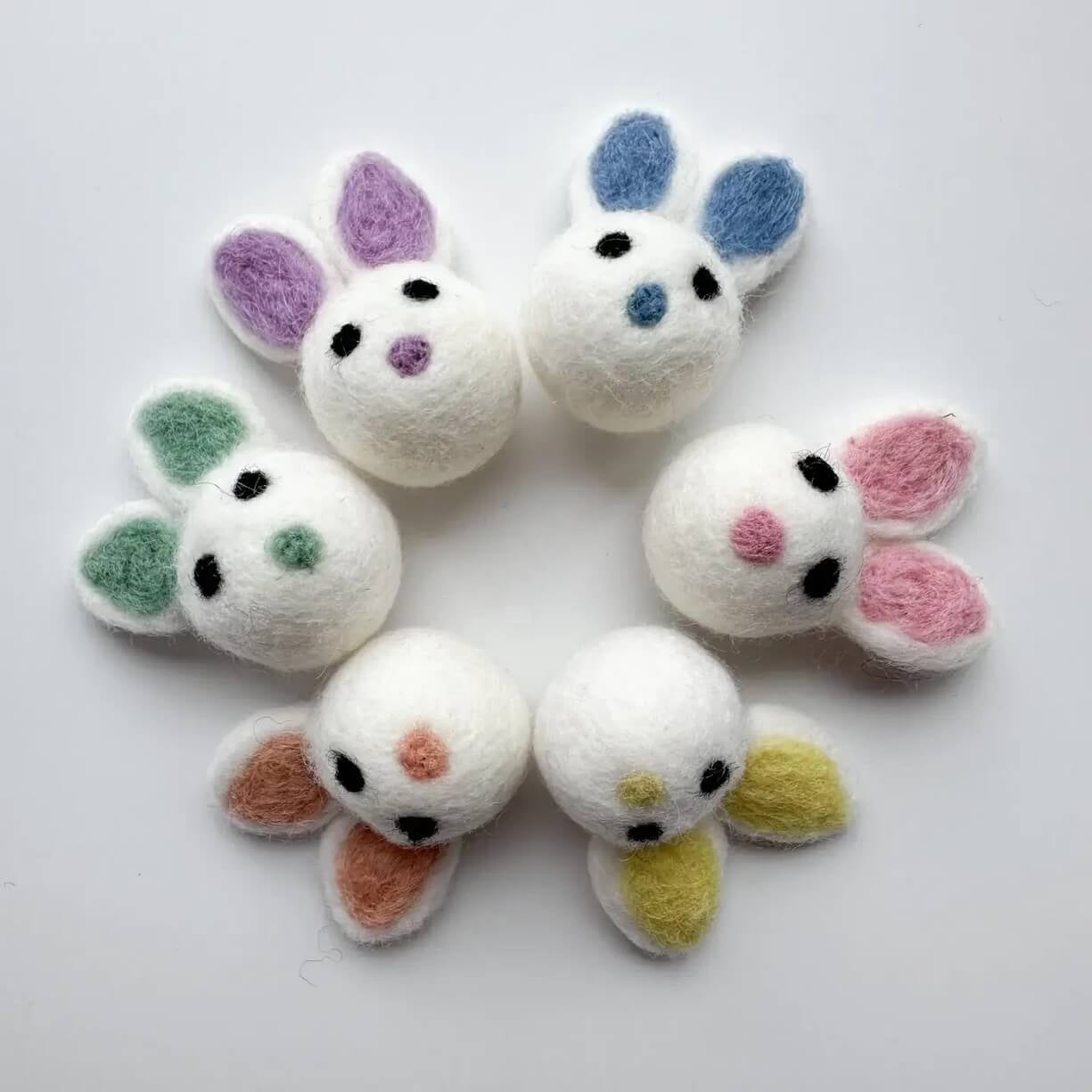 A grouping of six easter bunny felted wool cat toys.