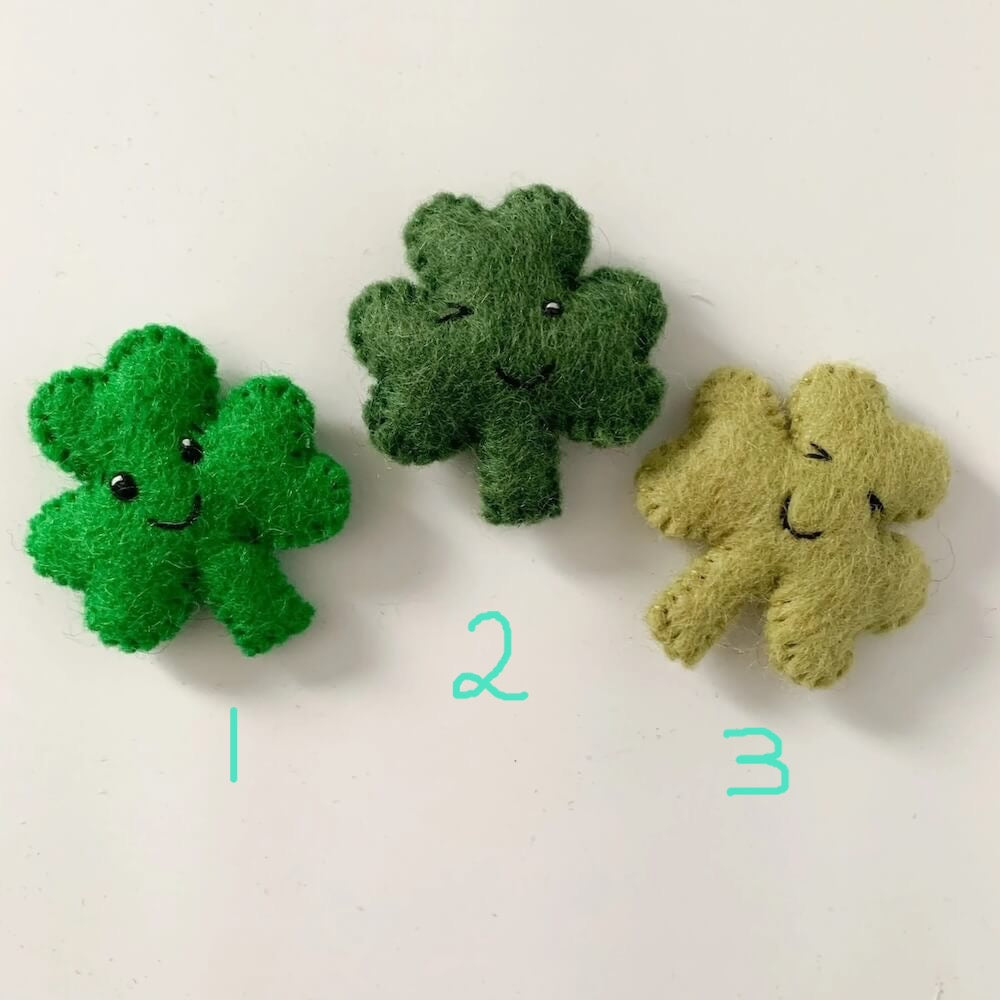 Three wool shamrock cat toys.