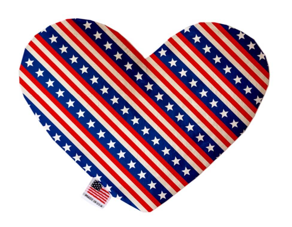 4th of July themed heart shaped squeaker dog toy in red, white and blue, with Stars and Stripes printed throughtout. Made in USA label on bottom trim.