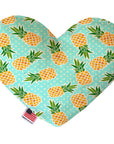 Heart shaped squeaker dog toy. Blue background with yellow pineapples and a white polka dot print. Made in USA label on bottom trim.