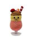 Knit Knacks "Daiquiri" handmade organic cotton dog toy. Anthropomorphic daiquiri drink in a glass with a smiling face and a straw on its head. Layered colors from top to bottom: brown, yellow, peach and white.