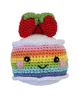 Knit Knacks "Rainbow Cake" handmade organic cotton dog toy. Smiling anthropomorphic cake with rainbow layers and strawberries on its head.