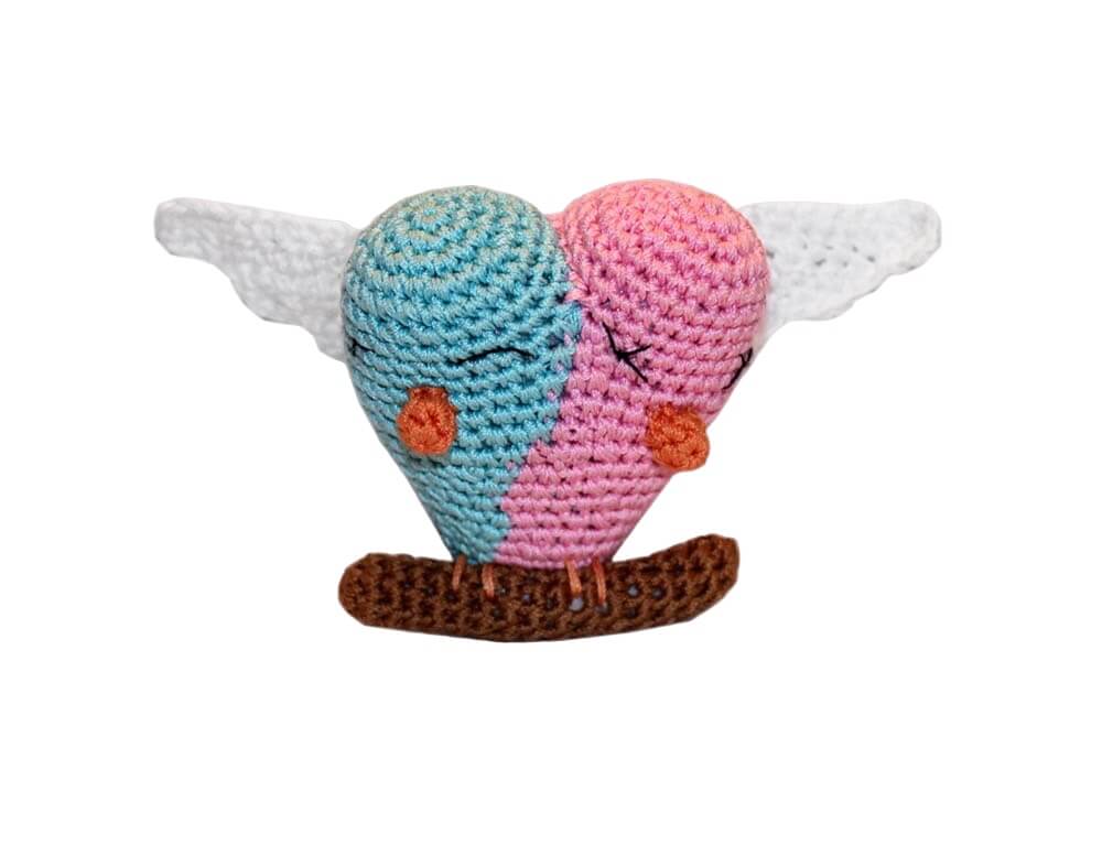 Knit Knacks "Lovebirds" organic cotton handmade dog toy. Lovebirds in blue and pink sitting close to one another on a branch with their wings spread out.