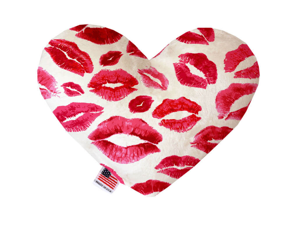 Heart shaped squeaker dog toy. White background with red lips printed throughout. Made in USA label on bottom trim.
