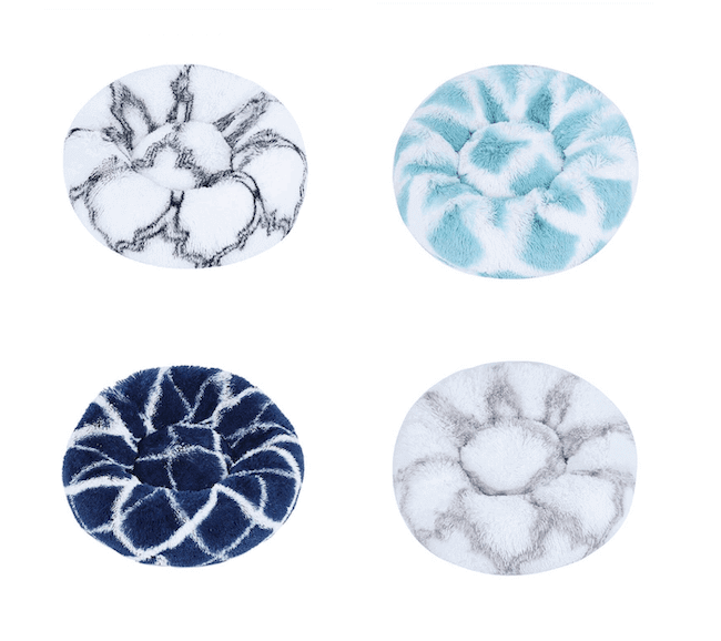 Variety of plush donut pet beds in different marble patterns and colors.