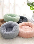 Mixed variety of donut plush beds in various colors.