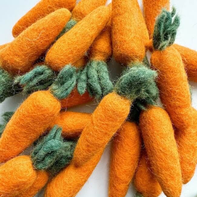Grouping of orange carrot felted wool cat toys.