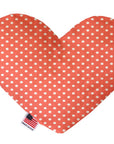 Heart shaped squeaker dog toy. Orange background with white polka dots. Made in USA label on bottom trim.