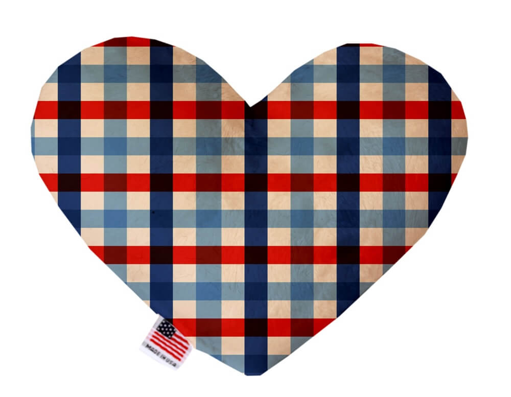 Heart shaped squeaker dog toy in red, white and blue plaid print. Made in USA label on bottom trim.